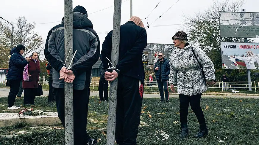 Tied to posts in Kherson